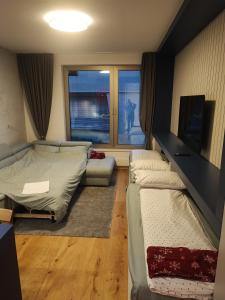 Ένα ή περισσότερα κρεβάτια σε δωμάτιο στο Apartman Olaf Bjelašnica
