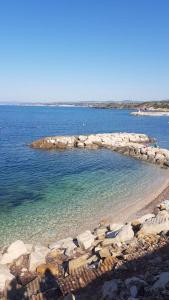 a group of rocks on a beach in the water at STUDIO REFAIT À NEUF BORD DE MER in Six-Fours-les-Plages