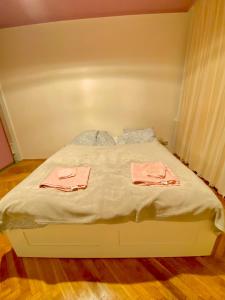 a bed with two pink towels on top of it at Cheap entire apartment in a super location in Kraków