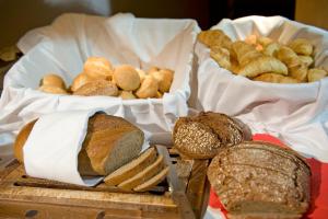 a bunch of different types of bread on a table at Quellenhof UNIQUE in Leukerbad