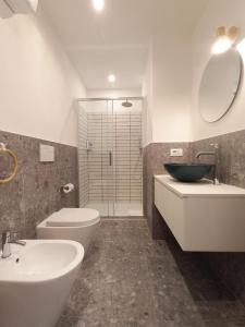 ein Bad mit einem Waschbecken, einem WC und einer Dusche in der Unterkunft Appartamento Magnolia in Mailand