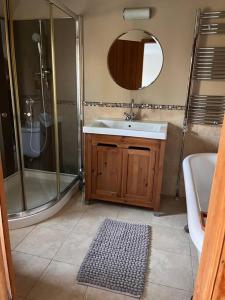 a bathroom with a sink and a shower and a tub at The Paddocks in Moulton Chapel