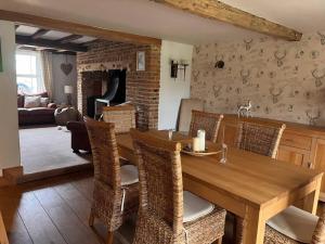 a dining room with a wooden table and chairs at The Paddocks in Moulton Chapel