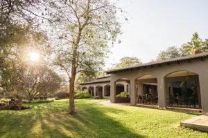 a house with a grass yard in front of it at Last Word Madikwe in Madikwe Game Reserve