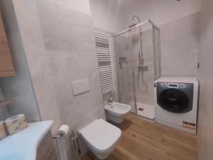 a bathroom with a shower and a toilet and a sink at MGH Family Apartment Aprica - Gran Paradis in Aprica +16 photos