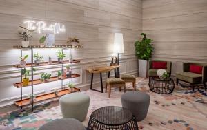 een lobby met stoelen en een tafel en planten bij Fraser Suites Singapore in Singapore