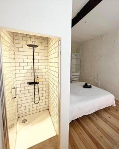 a small bedroom with a shower in a brick wall at GiGi Home's in Antwerp