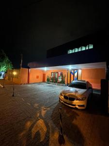 a car parked in front of a building at night at Itajubá Classic Hotel Goiânia in Goiânia