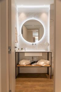 a bathroom with a sink and a mirror at Nicolas Centrale-Smart City Suites in Igoumenitsa