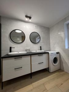 a bathroom with two sinks and a washing machine at WOW HOME in Warsaw