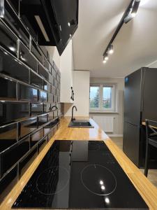 a kitchen with black appliances and a counter top at WOW HOME in Warsaw
