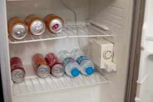 a refrigerator filled with lots of cans of soda at La Lisa Hotel in Hanoi