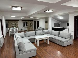 a living room with a couch and a table at TownHouse with pool in Yerevan
