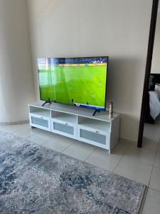 a flat screen tv sitting on a white entertainment center at sharja p702 in Sharjah