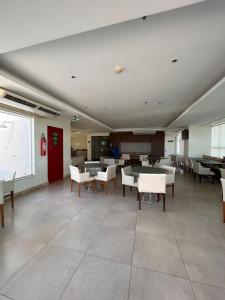 a dining room with tables and chairs in a building at SM915 Apart Hotel aconchegante e ótima localização in Brasilia