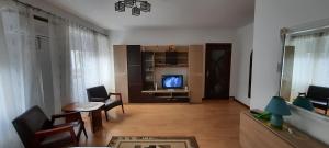 a living room with a couch and a tv in it at Ultracentral free private parking in Ploieşti