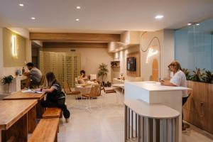 a group of people sitting at tables in a restaurant at En Pausa in San Rafael