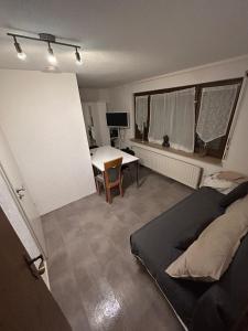 a bedroom with a bed and a table in it at TIME OUT - 3 Zimmer Wohnung mitten in Plochingen in Plochingen