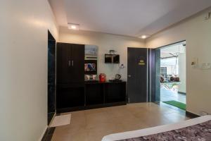 a kitchen with black cabinets and a sliding glass door at Saavaj Resort in Sasan Gir