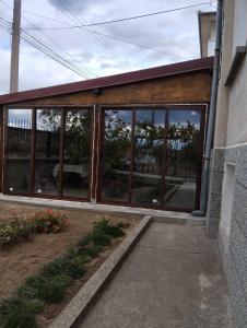 a building with large glass windows on the side of it at Velkovski Guest House in Hisarya