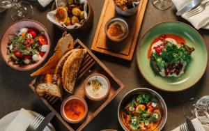 a table topped with plates of food and bowls of food at Radisson Blu Hotel at Porsche Design Tower Stuttgart in Stuttgart