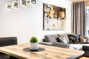 a living room with a table and a couch at Montanara Lodge in Brand