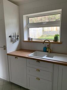 a kitchen with a sink and a window at Tenby house for 6 with 2 parking spaces in Pembrokeshire +29 photos