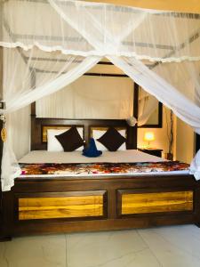 a bedroom with a large bed with a canopy at Villa D40 in Weligama
