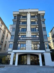 a building with a sign that reads management suites at MARASIUM SUITES in Kahramanmaraş