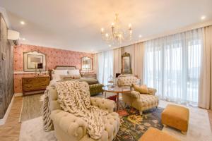 a bedroom with a bed and a chandelier at The Weinberg Urban Pod in Windhoek