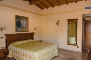 a bedroom with a bed and a mirror at Hotel Quadrifoglio Roma Eur in Mostacciano