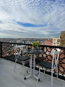 a table and chairs on a balcony with a view at TAKSİM LARİSSA RESİDENCE in Istanbul
