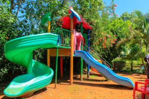 a playground with a slide in a park at Bubbles Restaurant Thika in Thika