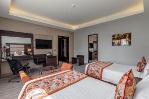 Postel nebo postele na pokoji v ubytování Athena Hotel Kampala