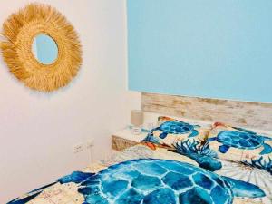 a bedroom with a bed and a mirror on the wall at La Terraza Fuerteventura in Puerto del Rosario