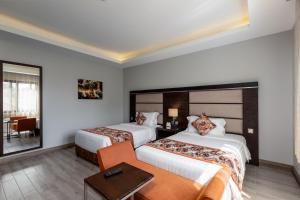 Postel nebo postele na pokoji v ubytování Athena Hotel Kampala