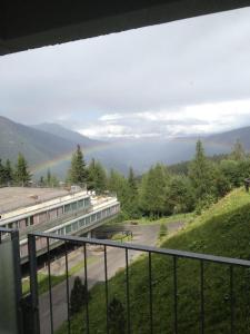 a view of a building with a rainbow in the distance at ABITARE MARILLEVA in Trento