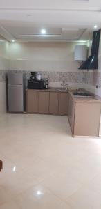 an empty kitchen with a stove and a refrigerator at Amouage résidence 2 in Mirleft