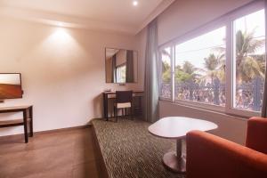 ein Hotelzimmer mit einem Tisch und einem Fenster in der Unterkunft Hotel Star City in Chennai