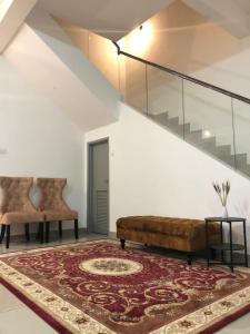a living room with a couch and a rug at D' HOME MERIDIAN in Kluang