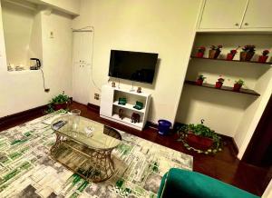 a living room with a table and a tv at Formidable of Cairo in Cairo
