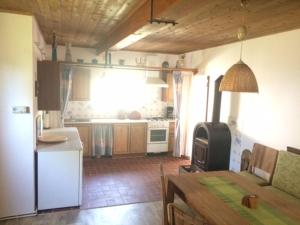 eine Küche mit Tisch und eine Küche mit Herd in der Unterkunft Ferienhaus Uphaus in Scharpitz in Güstrowerhöfen