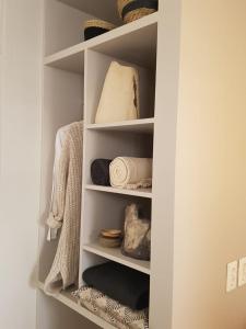 a closet filled with shelves with towels and baskets at The Superstay Boutique guestroom in Amsterdam