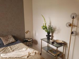 a bedroom with a bed and a table with a vase of flowers at The Superstay Boutique guestroom in Amsterdam