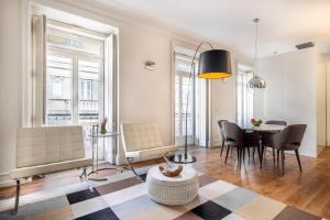 a living room with a table and chairs at Chiado Trindade Apartments | Lisbon Best Apartments in Lisbon