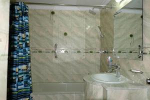 a bathroom with a sink and a shower at Hotel Saint Martin Ltd. in Chittagong