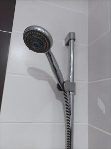 a shower with a shower head in a bathroom at Fitness Pension in Sulingen