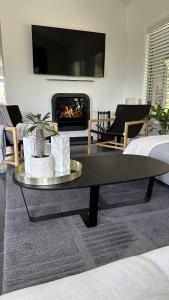 a living room with a coffee table and a fireplace at Mike's Kangaroo Valley in Kangaroo Valley