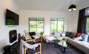 a living room with a couch and a table at Mike's Kangaroo Valley in Kangaroo Valley