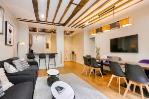 a living room with a couch and a table at Urban Flat 73 - Luxury Parisian Flat near Les Halles Rivoli in Paris